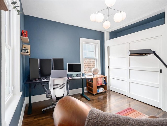 office area with dark wood-type flooring and baseboards