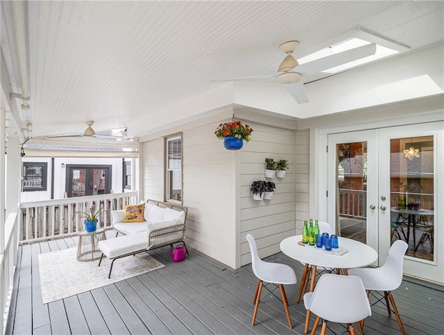wooden terrace featuring ceiling fan and french doors