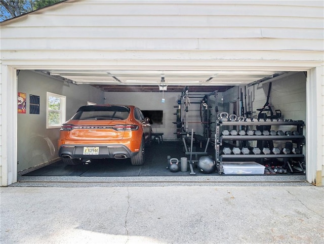 garage featuring concrete driveway