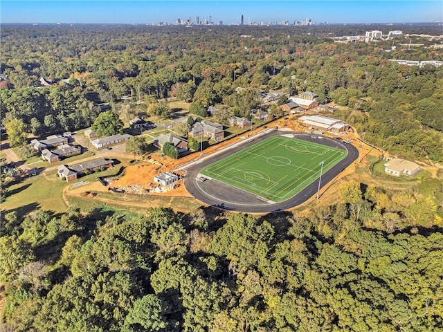 birds eye view of property featuring a forest view