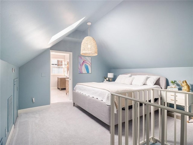 bedroom with baseboards, vaulted ceiling, and light colored carpet