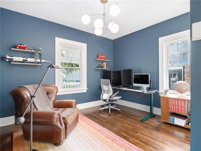 home office with baseboards, a chandelier, and wood finished floors