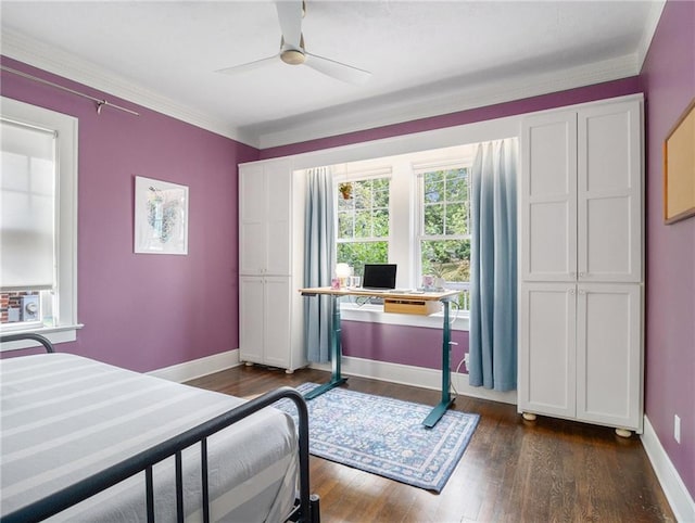 bedroom with dark wood-style floors, ornamental molding, baseboards, and ceiling fan