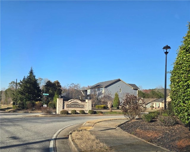 view of road featuring curbs, street lights, and sidewalks