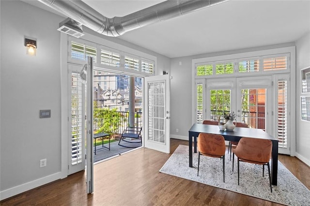 1029 Piedmont Ave NE Unit 102, Atlanta, GA 30309 - dining space featuring dark wood-type flooring, french doors, baseboards, and a healthy amount of sunlight