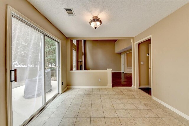 12060 Carriage Park Ln, Duluth, GA 30097 - unfurnished room with a textured ceiling, light tile patterned flooring, and baseboards