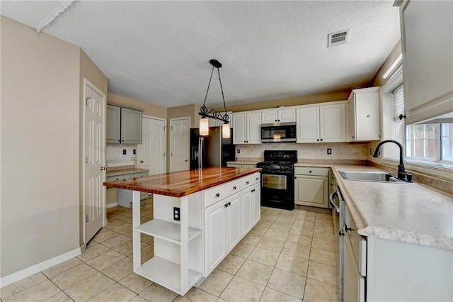 12060 Carriage Park Ln, Duluth, GA 30097 - kitchen with stainless steel microwave, gas range, black fridge with ice dispenser, a sink, and open shelves