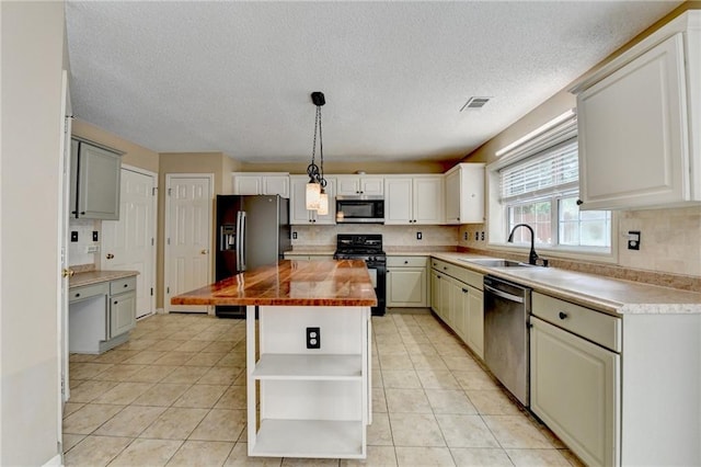 12060 Carriage Park Ln, Duluth, GA 30097 - kitchen featuring stainless steel appliances, open shelves, a sink, tasteful backsplash, and a textured ceiling