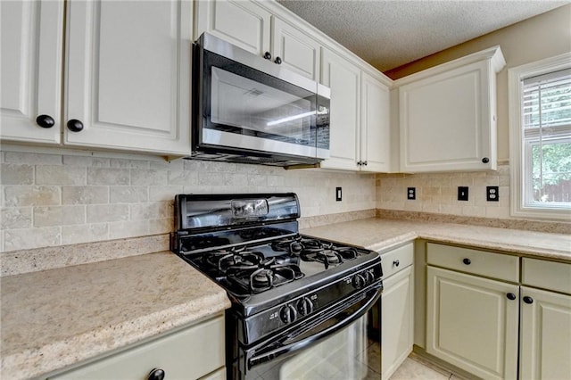 12060 Carriage Park Ln, Duluth, GA 30097 - kitchen featuring gas stove, stainless steel microwave, light countertops, tasteful backsplash, and a textured ceiling