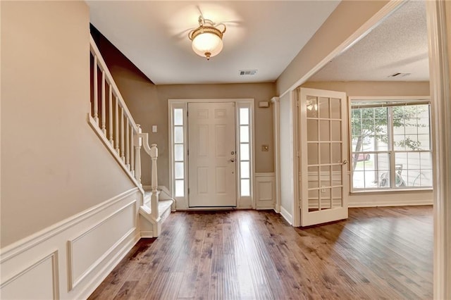 12060 Carriage Park Ln, Duluth, GA 30097 - entrance foyer featuring a decorative wall, wood finished floors, stairs, and a wainscoted wall