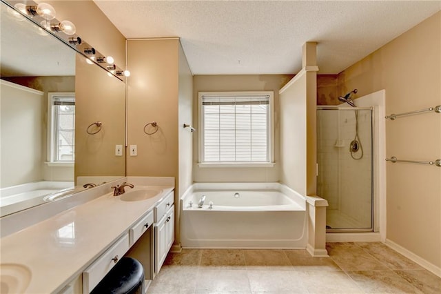12060 Carriage Park Ln, Duluth, GA 30097 - bathroom featuring a bath, double vanity, a stall shower, a textured ceiling, and baseboards