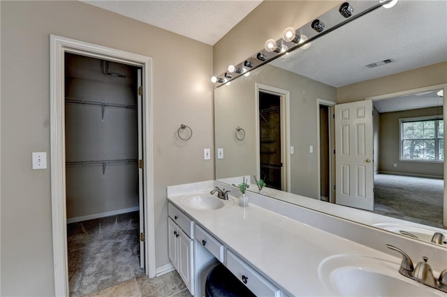 12060 Carriage Park Ln, Duluth, GA 30097 - full bath with double vanity, baseboards, and a walk in closet