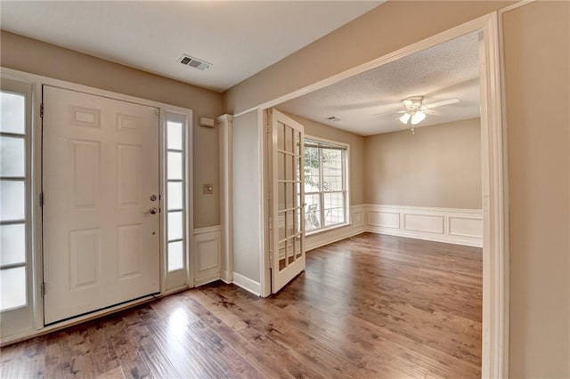 12060 Carriage Park Ln, Duluth, GA 30097 - entryway with a wainscoted wall, a decorative wall, wood finished floors, and ceiling fan