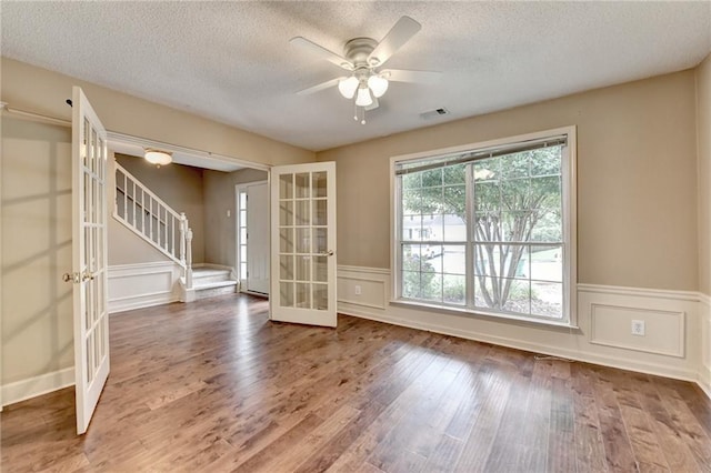 12060 Carriage Park Ln, Duluth, GA 30097 - unfurnished room featuring french doors, a textured ceiling, stairway, ceiling fan, and wood finished floors
