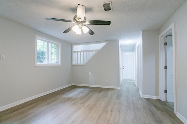 740 Stoneside Ct, Stone Mountain, GA 30083 - empty room with wood finished floors, a ceiling fan, baseboards, and a textured ceiling