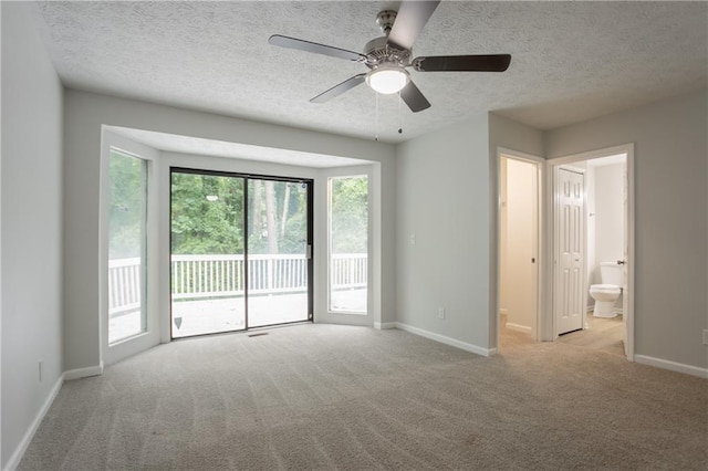 740 Stoneside Ct, Stone Mountain, GA 30083 - carpeted empty room featuring baseboards, a textured ceiling, and a ceiling fan