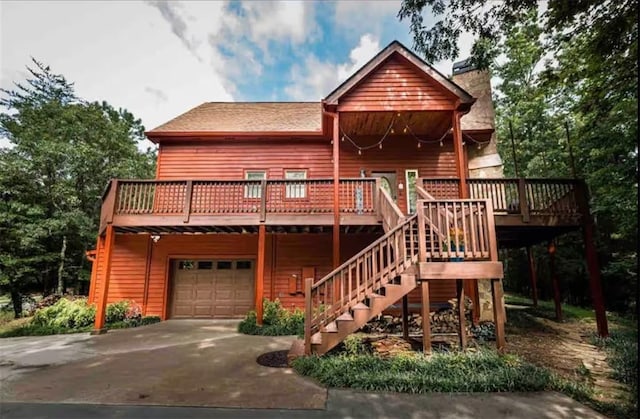 view of front of house featuring a garage and a deck