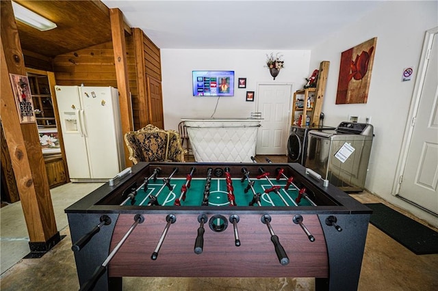 rec room featuring washing machine and clothes dryer and concrete floors