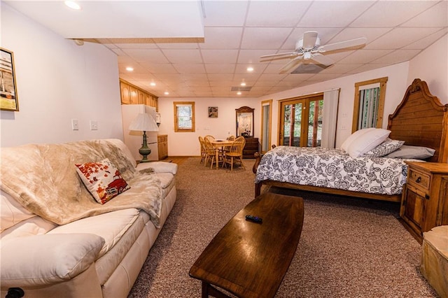 carpeted bedroom with a paneled ceiling, access to outside, and ceiling fan