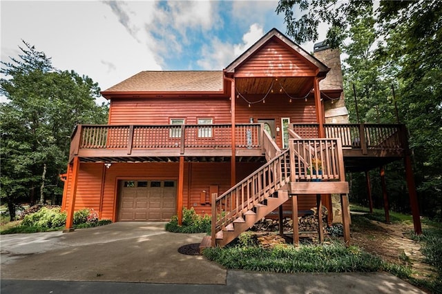 log cabin featuring a garage and a deck