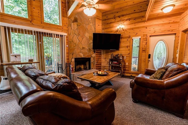 living room featuring high vaulted ceiling, a fireplace, beamed ceiling, carpet, and wooden ceiling