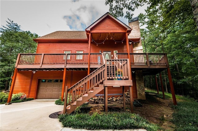 view of front facade featuring a garage and a wooden deck