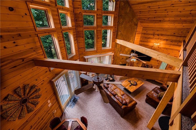 interior space featuring wood walls, lofted ceiling, carpet flooring, and wooden ceiling