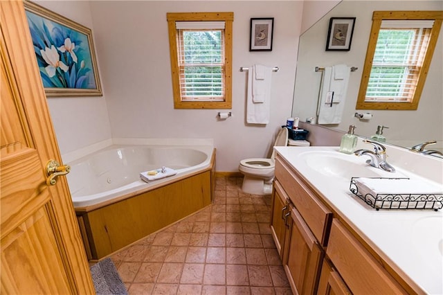 bathroom featuring vanity, a tub, and toilet