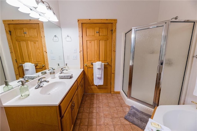 bathroom with an inviting chandelier, vanity, and a shower with door