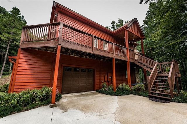 view of front of home featuring a wooden deck and a garage