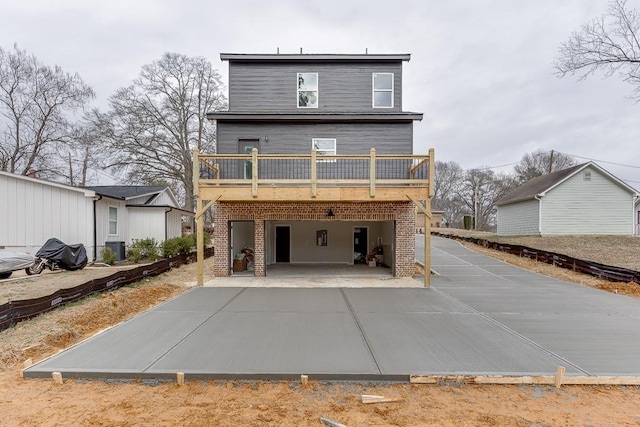 back of house with a garage and a deck