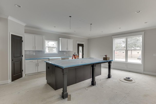 kitchen with white cabinetry, a center island, and a breakfast bar area