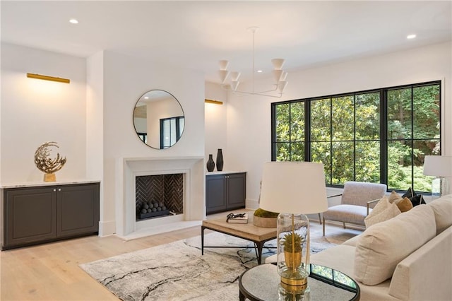 3292 Lenox Pl NE, Atlanta, GA 30324 - living area with light wood finished floors, recessed lighting, and a chandelier