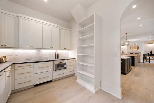3292 Lenox Pl NE, Atlanta, GA 30324 - kitchen with open shelves, light wood finished floors, tasteful backsplash, and recessed lighting