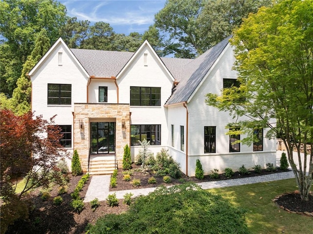 3292 Lenox Pl NE, Atlanta, GA 30324 - view of front of home with a front lawn, stone siding, and roof with shingles