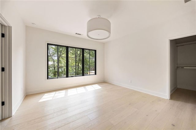 3292 Lenox Pl NE, Atlanta, GA 30324 - unfurnished bedroom with light wood-style flooring and a spacious closet