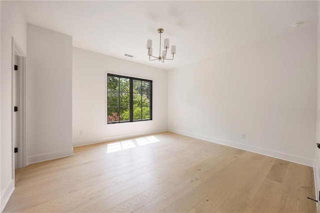3292 Lenox Pl NE, Atlanta, GA 30324 - empty room with a chandelier and light wood-type flooring
