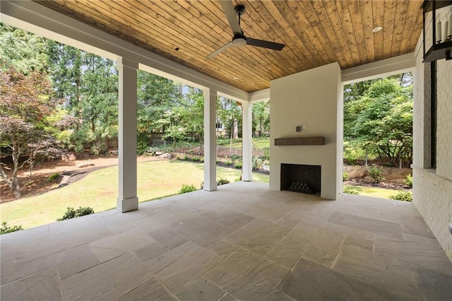 3292 Lenox Pl NE, Atlanta, GA 30324 - view of patio with a fireplace, a ceiling fan, and view of wooded area