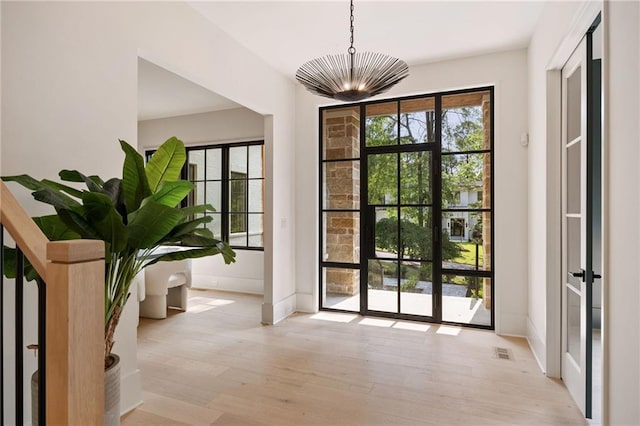 3292 Lenox Pl NE, Atlanta, GA 30324 - entryway featuring wood finished floors and a chandelier