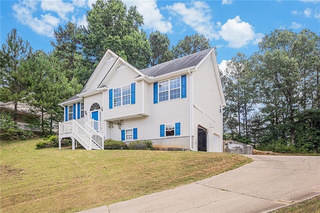 view of front of house with a garage and a front lawn