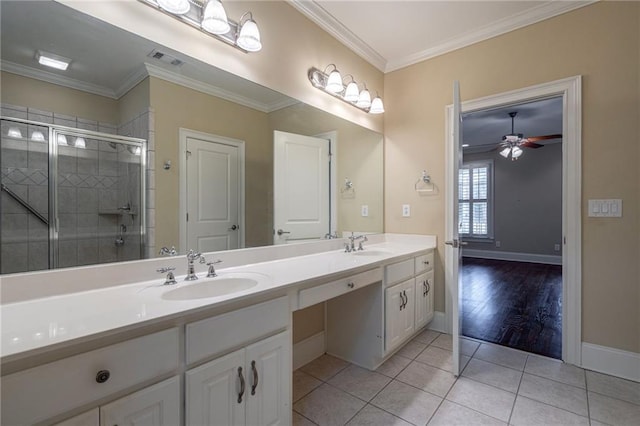 bathroom featuring a sink, ornamental molding, a shower stall, tile patterned floors, and double vanity