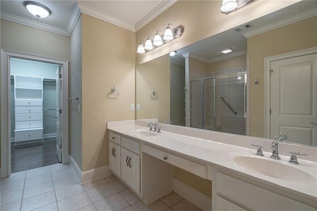 full bathroom with ornamental molding, a stall shower, tile patterned flooring, and a sink