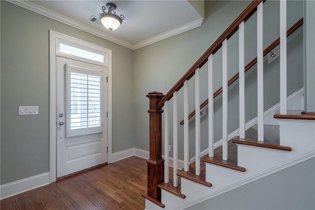 entrance foyer featuring baseboards, stairs, ornamental molding, and wood finished floors