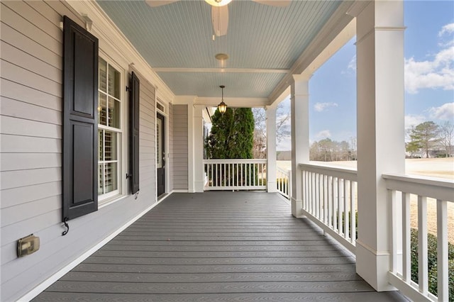 wooden terrace featuring a porch and a ceiling fan