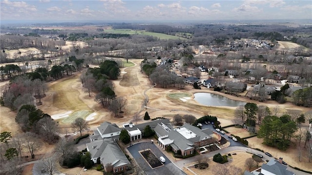 drone / aerial view with golf course view and a water view