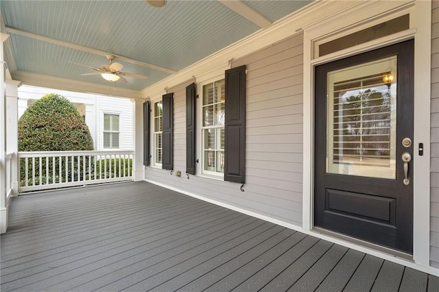 deck with covered porch and a ceiling fan