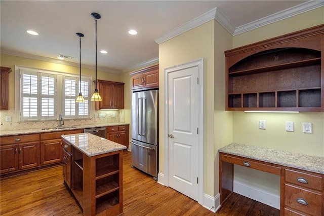 kitchen with stainless steel appliances, wood finished floors, a sink, open shelves, and built in desk