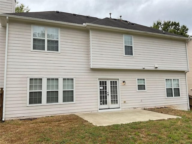 rear view of house with a yard, a patio, and a chimney