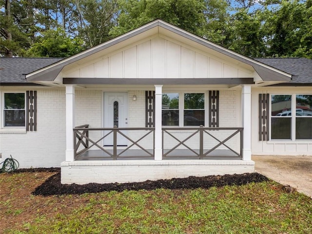 8535 Hiram Acworth Hwy, Dallas, GA 30157 - view of front of property with a porch, brick siding, board and batten siding, and roof with shingles