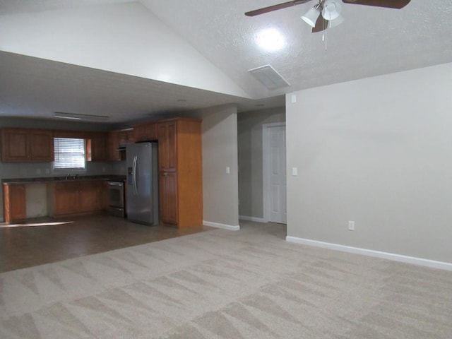 152 Royal Oaks Ln, Dahlonega, GA 30533 - kitchen featuring fridge with ice dispenser, range, ceiling fan, dark countertops, and vaulted ceiling
